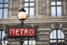 Red metro sign with light in Paris, France