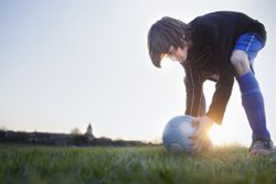 Young boy playing soccer