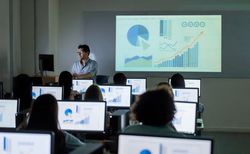 Teacher giving a lecture at the IT classroom