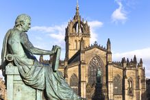Statue of David Hume in front of cathedral