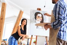 Artist making portrait of young woman