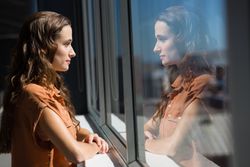 Side view of thoughtful businesswoman looking through window