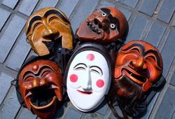 A heap of traditional Korean Hahoe masks, used for festivals and rituals.