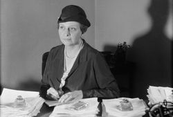 Photograph of Frances Perkins at her desk