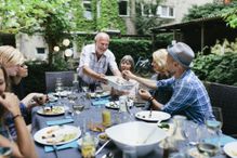 Image of a family having a meal outside