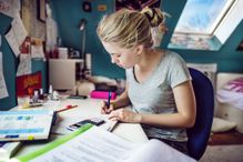 Yound womand doing her homework at her desk