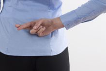 Back view of woman with crossed fingers