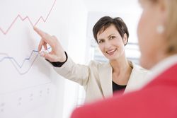 Woman Showing Another Woman a Chart