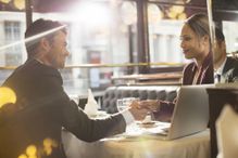 Business people shaking hands in a restaurant