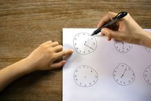 Young girl learning to read the time