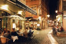 Lyon, People dining along cobbled street at night