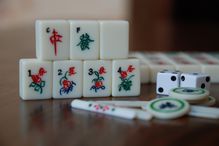 Mahjong tiles on a table facing the camera, full color photograph.