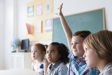 Student raising hand in classroom