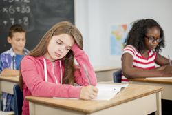 female student writing in class