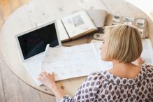 Woman at table looking at genealogical tree