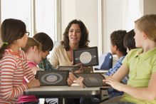 Teacher and students using digital tablets