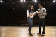 two kids on stage reading a script