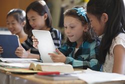 Students using digital tablets in class