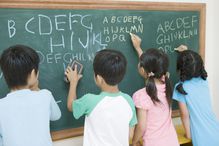 japanese students writing English on chalkboard