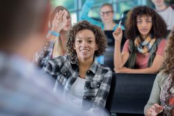 Confident college students answer question in class