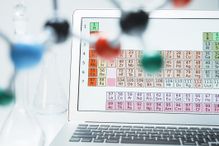 Lap top with periodic table and ball and stick molecular model