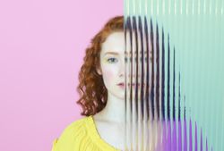 half of woman's face obscured by glass