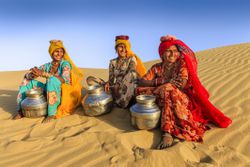 women carrying water from local well in Rajasthan, India