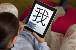 A student learning mandarin Chinese using education application on iPad tablet computer