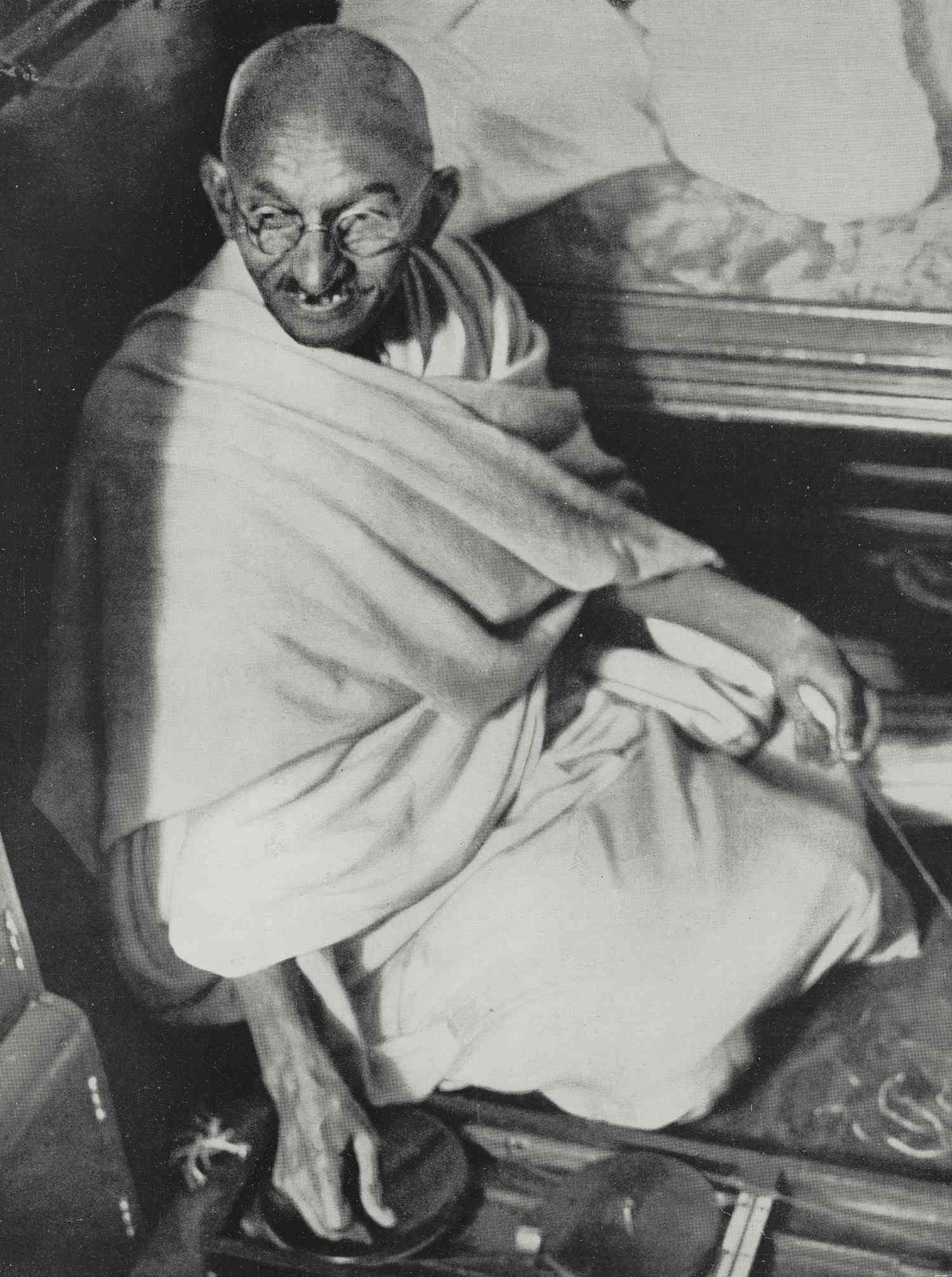 Mahatma Gandhi in robes sitting
