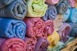 Rolls of different colored textiles.