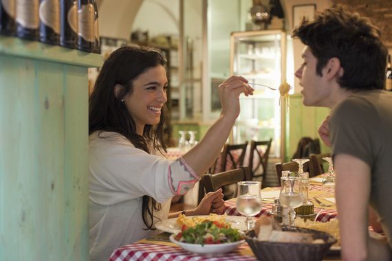 Happy young couple eating Italian together