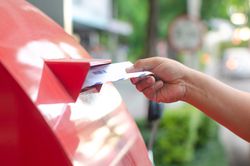 A right hand sending letter to post box