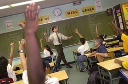 Classroom of students raising hands