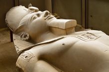 A limestone statue of Ramses II, lying on display