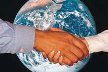 woman man shaking hands in front of photo of planet Earth