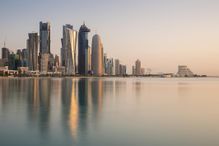 The skyline of Doha, Qatar&#39;s capital, reflects in the waters of the Persian Gulf.