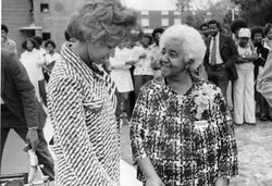 American inventor Marjorie Stewart Joyner (right) speaks with an unidentified woman at an outdoor event, late 1960s,black and white photograph.