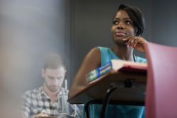 female student thinking at desk