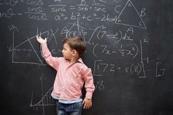 Child in front of a chalkboard