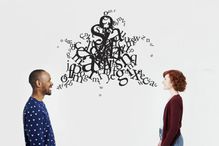 Man and woman with illustrated jumble of letters