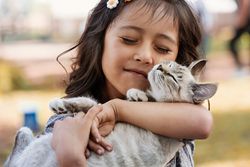 Girl holding kitten