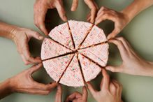 Hands grabbing pieces of cake