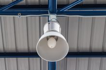 Overhead light hanging on factory truss