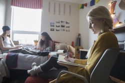 Female college students studying in dorm room