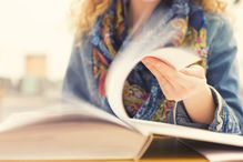 Student flipping through book; motion of turning pages