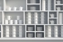 White, organized dishes in a cabinet