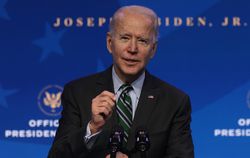 Joe Biden speaking behind a microphone