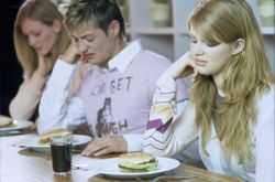 Young people with sickened faces looking at their burgers