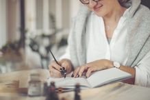 Woman writing in a calendar