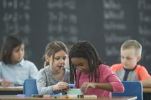 Kids in math class use stackable blocks for simple math